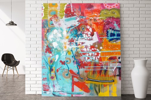 Photograph of large multi-colored abstract painting leaning against a white wall with furniture in the background for scale